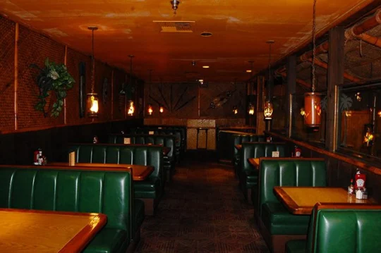Green leather booths lining a narrow dining room